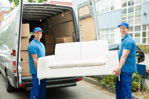 Man and van loading furniture in Swiss Cottage residential street