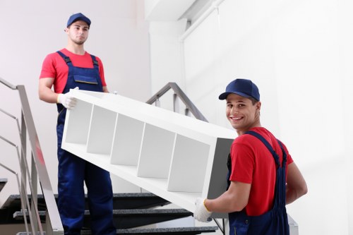 Student removal team handling boxes near a Swiss Cottage residential block